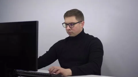 The young IT specialist looks at the documents and nervously throws them away. A Stock Footage 230330503
