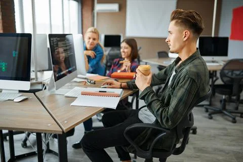 Young IT specialists works on computers in office Stock Photos
