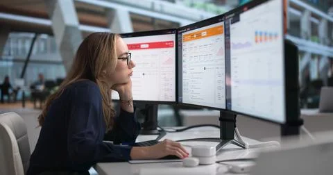 Young IT Support Specialist Feels Tired While Tracking Alerts On Computer. Stock Photos