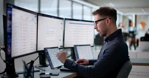 Young IT Support Specialist Managing Helpdesk Tickets Using Digital Software  Stock Photos