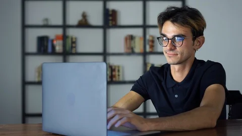 Young IT Technologist Working in the Office. Man Sitting at the Table Using Stock Footage 93300943