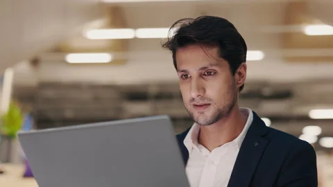 Young IT Worker Writing Code Using the Laptop While Sitting in the Lounge Zone. Stock Footage 303147907