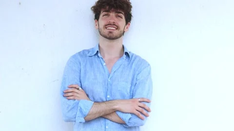 Young Italian man looking at the camera smiling while crossing his arms Stock Footage 198166536