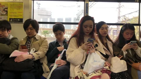 Young Japanese commuters on train Stock Footage