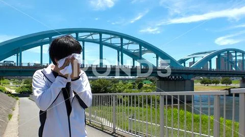 Young JAPANESE RUNNER MAN wiping sweat. Stock Photos