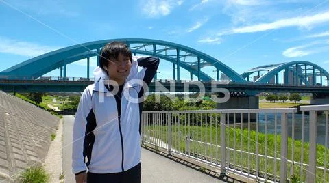 Young JAPANESE RUNNER MAN wiping sweat. Stock Photos