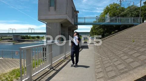 Young JAPANESE RUNNER MAN wiping sweat. Stock Photos