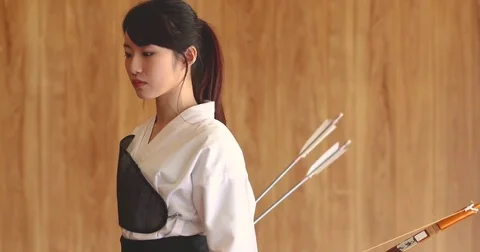 Young Japanese woman practicing traditional Kyudo archery Stock Footage