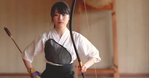 Young Japanese woman practicing traditional Kyudo archery Stock Footage