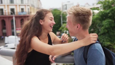 Young joyful couple hugging and laughing in city Stock Footage 92486227