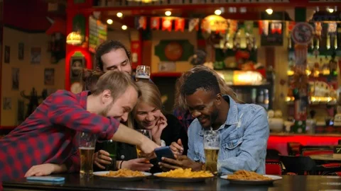Young joyful people taking selfie with black smartphone, snapping pictures for Stock Footage 114898523