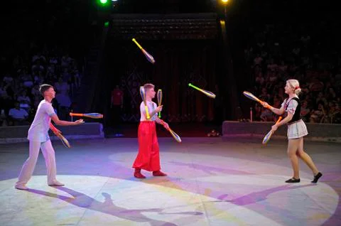 Young jugglers performing in the ring of the circus Stock Photos