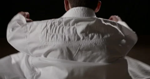 Young Karateka putting on Gi Video stock 48999399