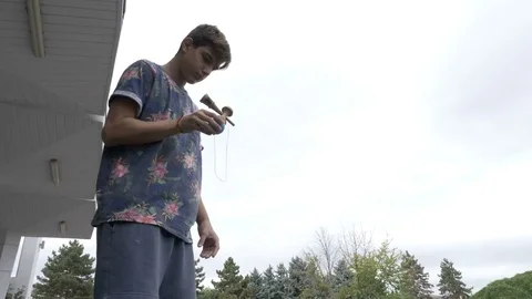 Young kendama player exercising advanced tricks and moves with kendama toy ou Stock Footage 81428585