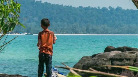 Young Khmer boy is looking at the ocean Stock Photos