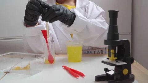 Young kid doing a scientific experiment Stock Footage 280684830