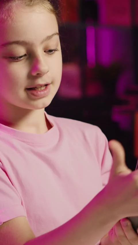 Young kid entertainer doing technology review of Bluetooth portable speaker Stock Footage 255592456