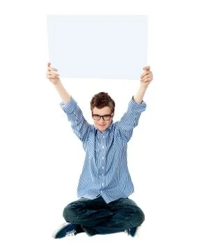 Young kid holding empty placard over his head Stock Photos