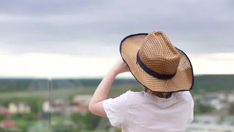 Young kid looking at the city through the binoculars, from the rooftop patio Stock Footage 161590276