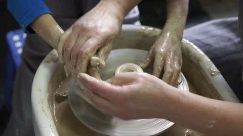 Young kid is making clay figure with pottery wheel. Close-up of Potter's hands Stock Footage 103051068