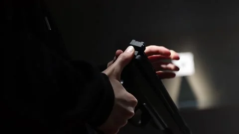 Young kid is opening top part of the gun to load the pellet. Video stock 171607944