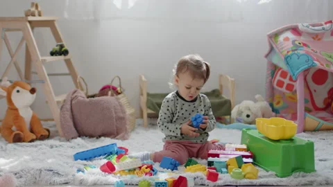 Young kid playing with plastic cube toys at home Stock Footage 236154550