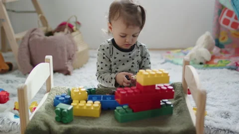 Young kid playing with plastic cube toys at home 스톡 동영상 236238831