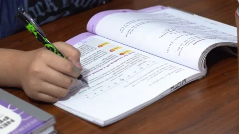 Young kid practising learning mathematics writing answers in home Stock Footage 139583330