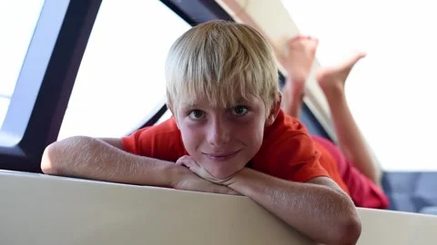 Young kid smiling and blinking to camera. Video stock 137672982