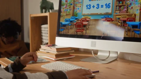 Young Kid Solving Math Sums on Computer with Colorful Interactive App Stock Footage 334973546