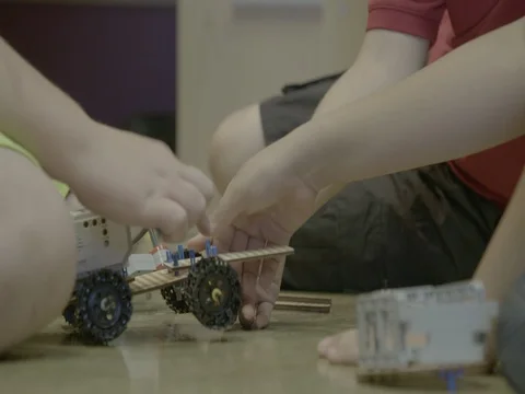 Young kids assembling Lego Mindstorm robots 動画素材 81532938