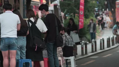 Young Koreans walking in Hongdae during Covid-19 Stock Footage 137363636