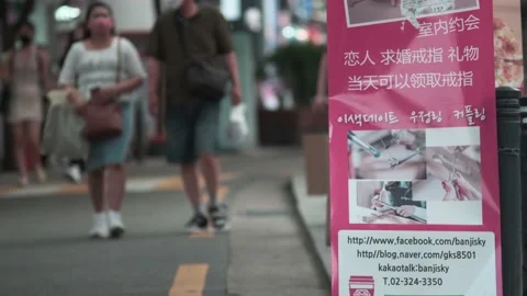 Young Koreans walking in Hongdae during Covid-19 Stock Footage 137363658