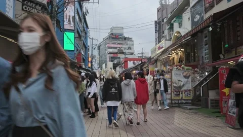 Young Koreans walking in Hongdae during Covid-19 Stock Footage 143855593