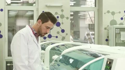 Young laboratory assistant intently observing the centrifuge in action Stock Footage 311990235