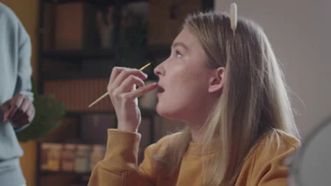 Young ladies are talking how to draw make-up better Stock Footage 170204315