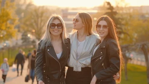 Young ladies fun evening walk girls inviting join Stock Footage 108474368