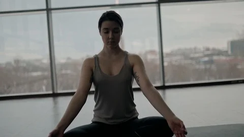 Young ladies meditating in studio Stock Footage 124289563