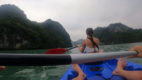 Young lady and man is kayaking in Halong Bay, Vietnam Stock Footage 321623344