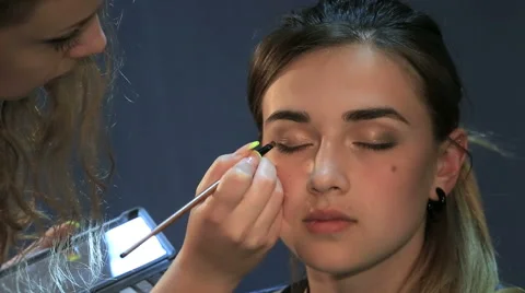 Young lady been applied with make up Video stock 54029306
