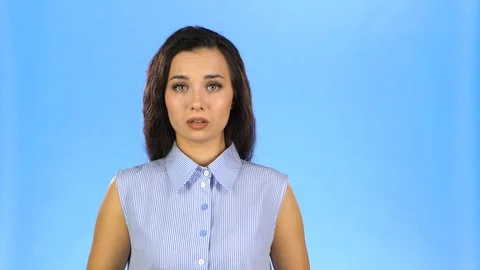 Young lady biting her lip and saying oops Stock Footage 117813883