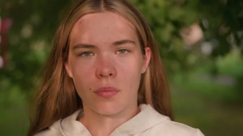 Young Lady with Bold Expression and Intense Gaze in Natural Outdoor Setting Stock Footage 293654776