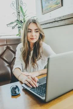 Young lady browsing the Internet at the cafe. Stock Photos