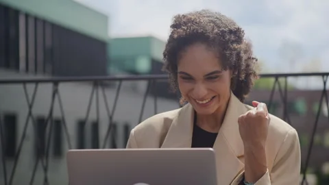 Young Lady Celebrating Achievement Using Laptop Outside Stock Footage 247921234
