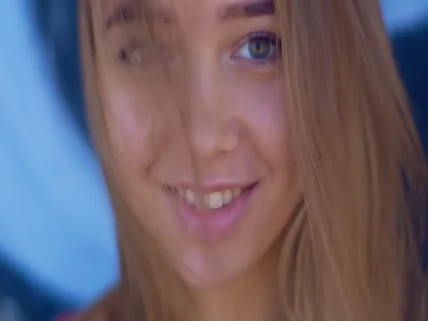 Young Lady corrects the hair while looking at the phone and smiling Video stock 84753439