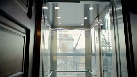 The young lady is entering the empty elevator Stockbeeldmateriaal 62026903