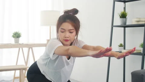 Young lady exercises using laptop to watching yoga video tutorial at home. Stock Footage 133990261