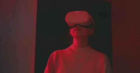 Young lady experimenting the virtual reality in pink neon light Stock Footage 201110023