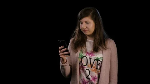 A Young Lady Gesturing Bingo and Using a Phone Stock Footage 86581230
