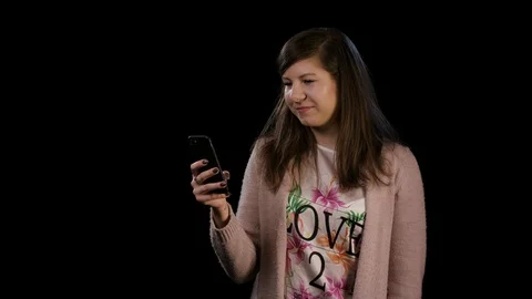 A Young Lady Gesturing Bingo and Using a Phone Stock Footage 86581467
